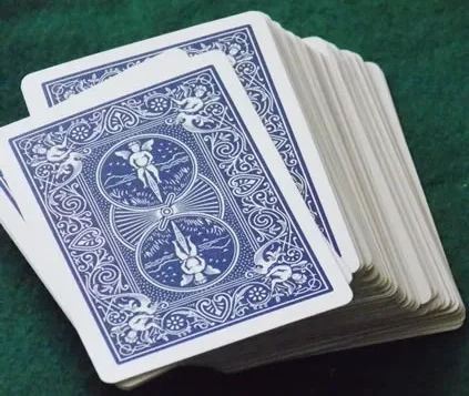 Deck of blue-backed playing cards on a green surface for the card game "Math War."